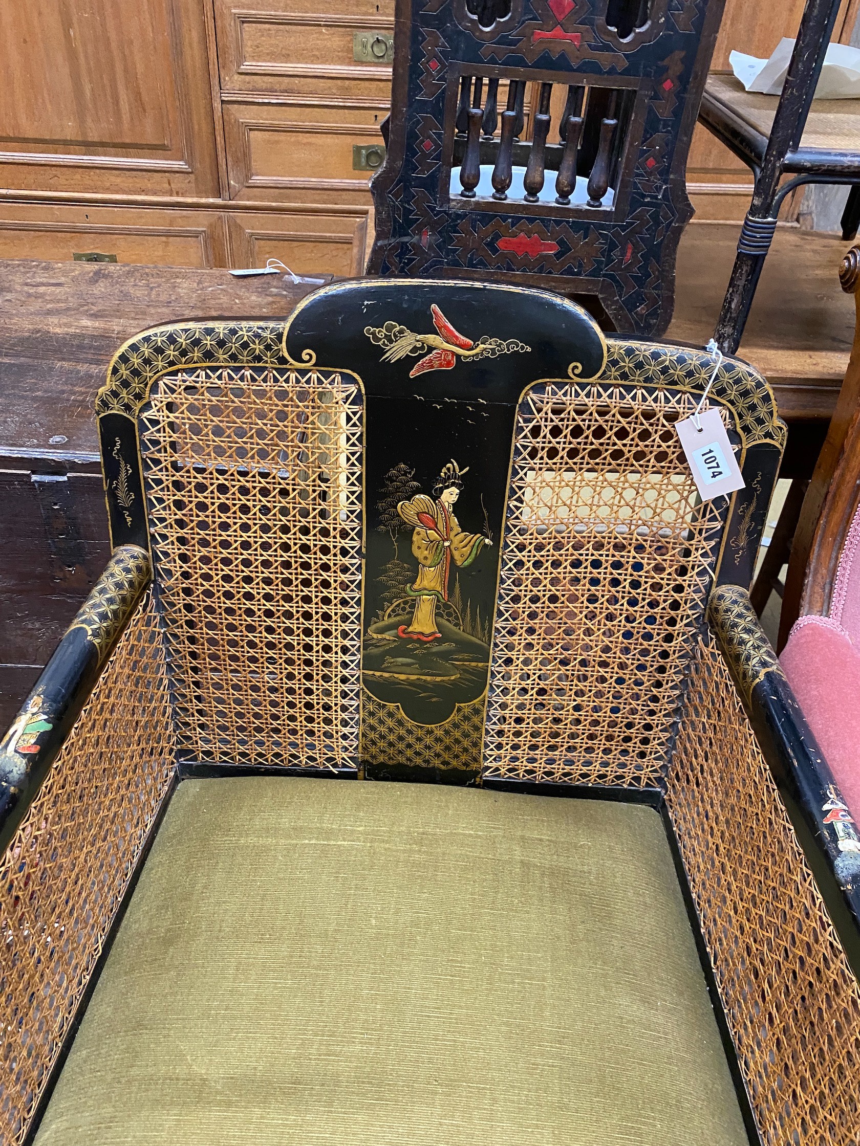 A 1920's Chinoiserie lacquer bergere armchair, width 64cm, depth 65cm, height 85cm